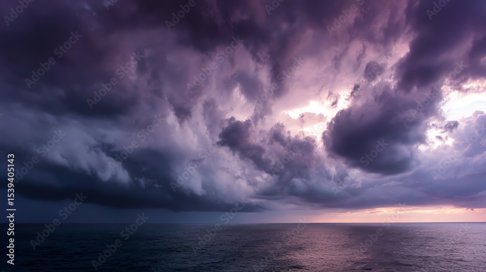 Fototapeta premium Dramatic ocean view with stormy clouds and twilight hues over the water.