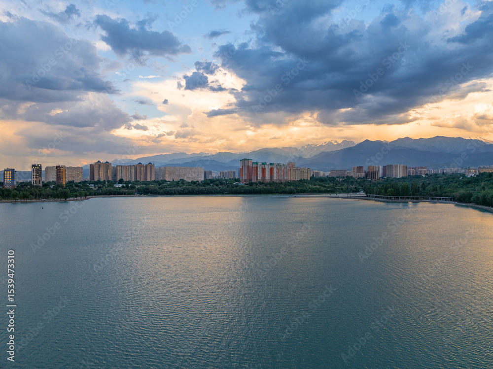 Naklejka premium Quadcopter view of high-rise buildings in the area of ​​Lake Sairan in the Kazakh city of Alaty on a picturesque summer evening