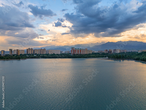 Quadcopter view of high-rise buildings in the area of ​​Lake Sairan in the Kazakh city of Alaty on a picturesque summer evening