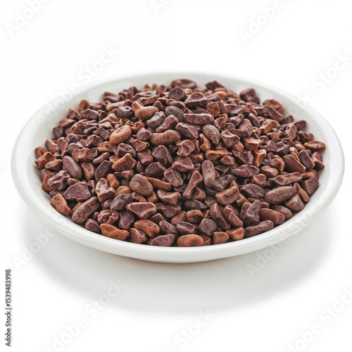Cacao nibs fill a white bowl showing natural texture and rich color appeal close-up