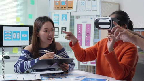 Virtual reality headset testing and collaborative feedback in modern design studio, Asian women developers exploring innovative technology and user experience prototype