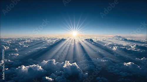 Sunbeams piercing a vast expanse of clouds.