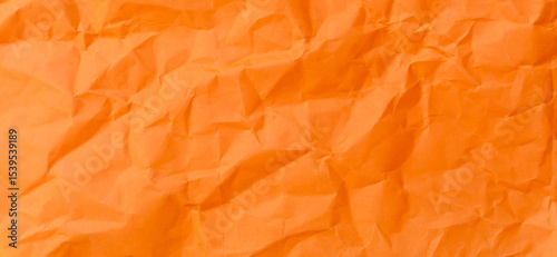 Top view and full frame of wrinkled or crumpled orange paper texture used as crumpled paper background texture in decorative art work