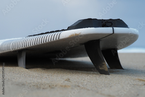 Close-up. White short surfboard near Ocean.