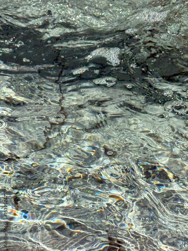 Fototapeta premium Flowing and bubbling fountain water surface