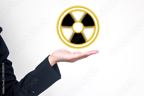 Nuclear presentation concept showing a hand holding a glowing radioactive symbol. Ideal for science, energy, safety warning, atomic power, radiation hazard, and environmental awareness visuals.