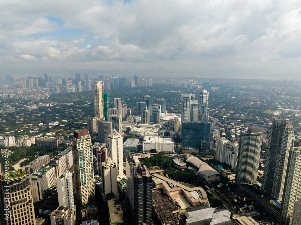 Fototapeta premium Aerial view of high rise buildings and residential towers in Makati City. Metro Manila, Philippines.