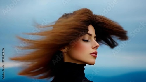 Windswept Beauty: A young woman with long brown hair, flowing freely in the wind, gazes serenely towards a distant horizon, her eyes closed in peaceful contemplation.