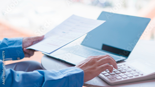 Tableau sur toile Financial management and expense calculation concept, professional analyzing financial reports and using calculator and laptop for budgeting