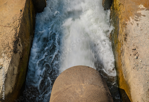 powerful water flowing out spillway dam