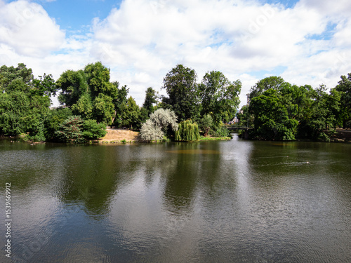 View to lake, trees and clouds in park