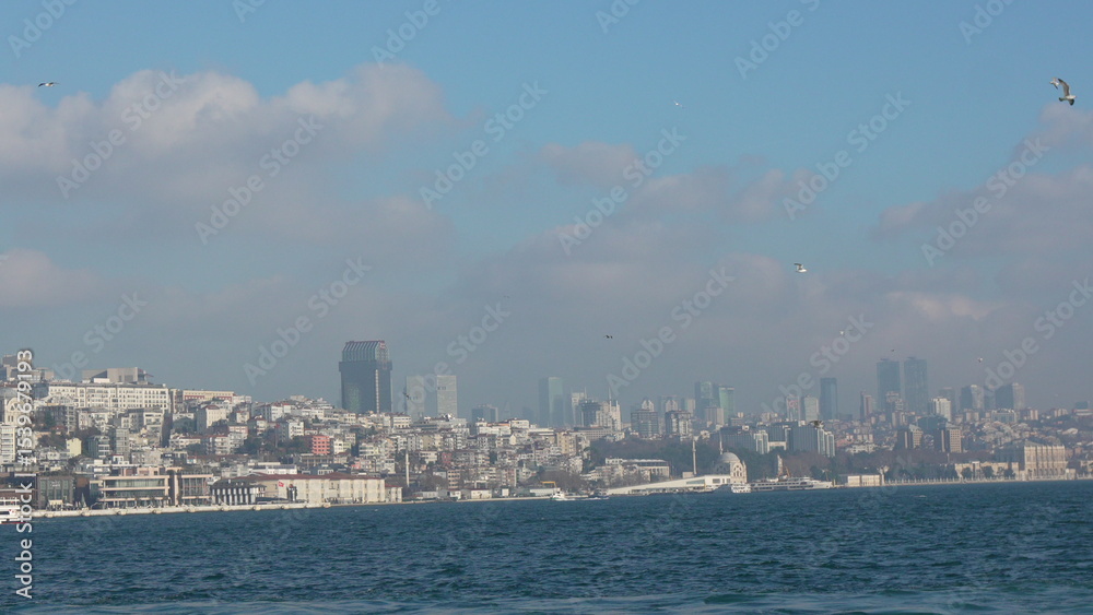 Fototapeta premium Istanbul Skyline Bosphorus View: Panoramic cityscape showcasing historical and modern architecture from the sea.