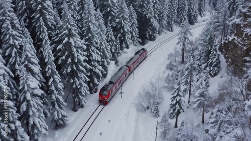 Scenic Winter Train Journey Through Snow-Covered Pine Forest Landscape in a Remote Area