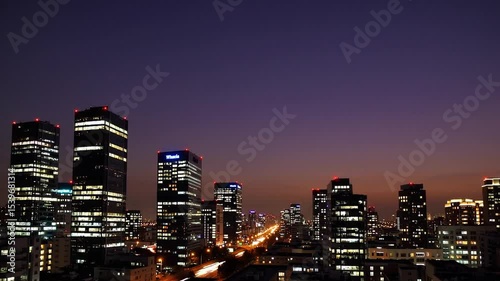 Urban skyline at dusk with glowing buildings and light trails showcasing city life and modern architecture