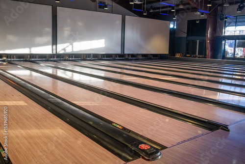 Modern bowling alley interior with multiple empty lanes and soft natural light, November 7, 2020