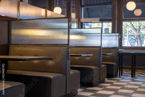 Booth seating inside a restaurant with natural light, checkerboard tile, and pendant lighting, San Francisco, CA, September 27, 2020