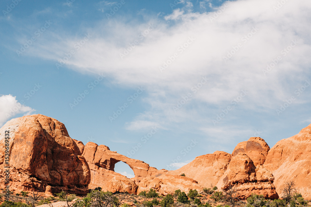 Fototapeta premium Skyline Arch framed by red rock cliffs in Arches National Park, Utah