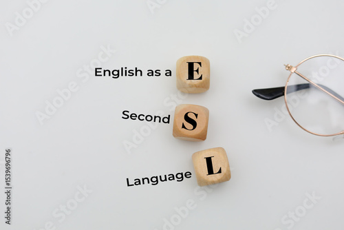 Wooden block with the letters ESL or the word English as a Second Language