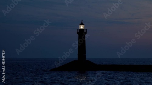 Serene Night View of a Luminous Lighthouse Guiding Vessels Over Calm Waters Under a Starry Sky