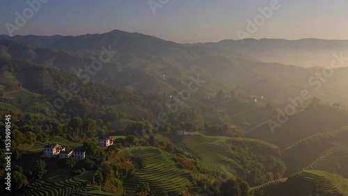 Breathtaking Aerial View of Lush Green Mountains and Rolling Hills Under Clear Blue Sky