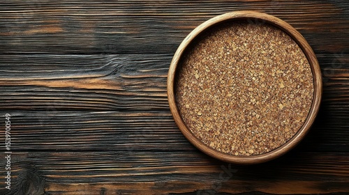 Wood bowl of seeds on dark stained wood surface