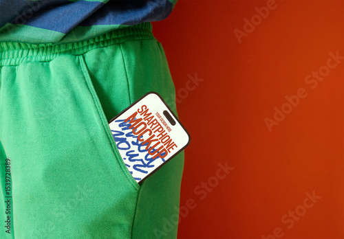 Mockup of Smartphone in Green Pants Pocket