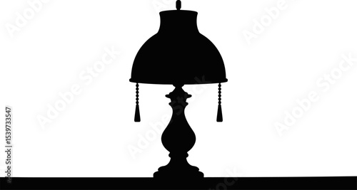 Silhouette of a vintage lamp with beaded tassels and a decorative base on a dark surface area