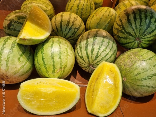 Fresh yellow watermelon on the market stall at supermarket. Slice of tasty yellow watermelon with juicy texture and seeds. Slices of yellow watermelon texture background ideal for fresh produce and he