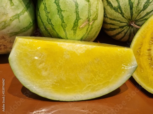 Fresh yellow watermelon on the market stall at supermarket. Slice of tasty yellow watermelon with juicy texture and seeds. Slices of yellow watermelon texture background ideal for fresh produce and he