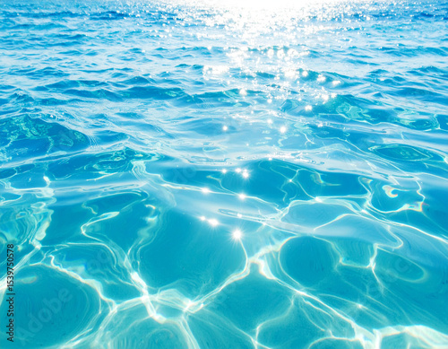Sparkling Water: Glimmering sunlight dances across the surface of crystal-clear water, creating a mesmerizing display of light and reflection. A vivid depiction of the ocean. 