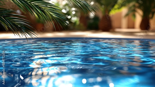 A detailed close-up of a swimming pool with ripples in the water, capturing the reflection of palm trees swaying above and the sunlight casting sparkling highlights.