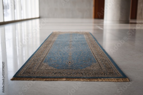 single intricate carpet or hallway runner lies flat on polished vast floor bathed in diffused natural light
