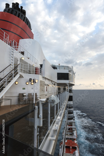 Red and black funnel of classic ocean liner cruise ship cruiseship Elizabeth Victoria against deep blue sky during cruise in summer	