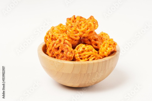A pile of spicy Indonesian crackers or Kerupuk with spiral twists, coated in red-orange chili powder and rich spices. Bold, flavorful, and appetite-boosting. Photographed against a white background.