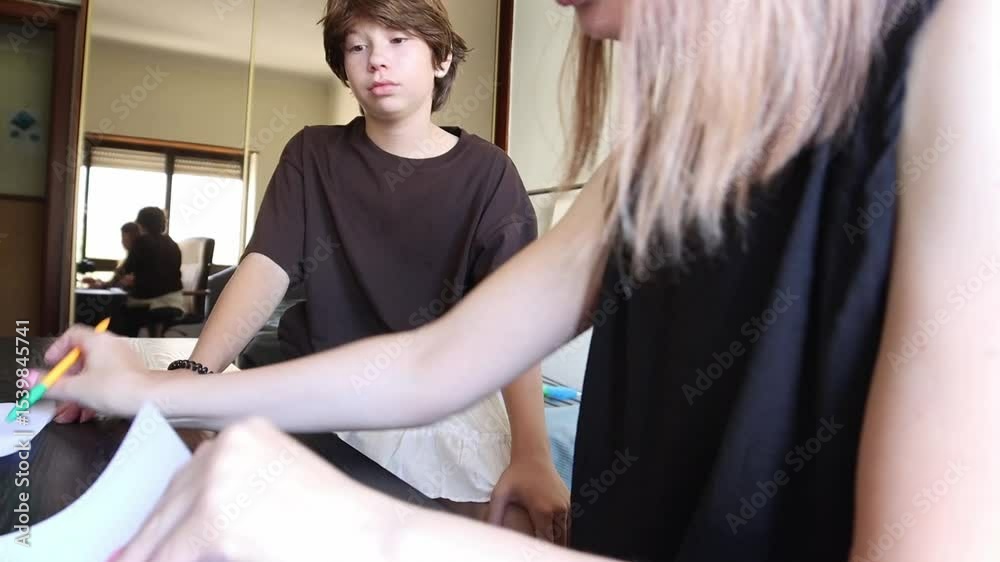 Private tutor helping young student with homework Private tutor helping young student with homework