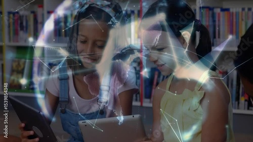 Girls tapping and swiping tablets in library causing network lines forming globe overlay for study