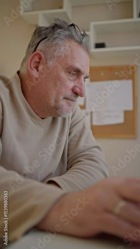 An elderly man exploring modern technology, learning to use new gadgets with curiosity and determination. A heartwarming scene of digital adaptation, learning, and intergenerational growth