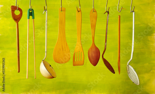 Vintage kitchen utensils on green background