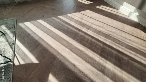 Natural wood laminate parquet floor. Room with floating laminate in new apartmen.  Cozy home interior, modern design