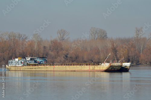 Barge on the river transports coal, sand, gravel