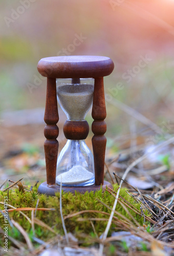  vintage hourglass on moss in park