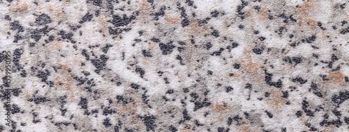 Granite stone texture with marble pattern in beige, black and white tones for kitchen countertop background