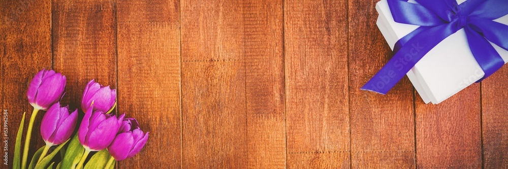 Fototapeta premium Flowers on wood floor with gifts