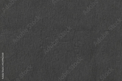 Dark gray textured surface is filling frame in flat design while showing fabric weave, copy space