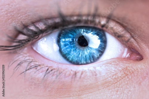 Close-up macro eye illustration is showing vivid blue iris with radial textures and cornea glare