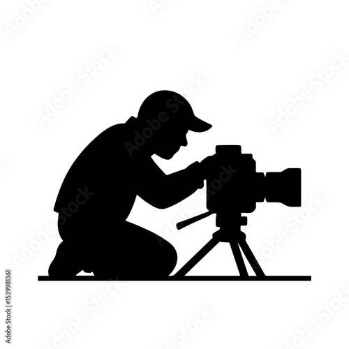Photographer kneeling while adjusting camera on tripod - Concept of Photographer's Day  