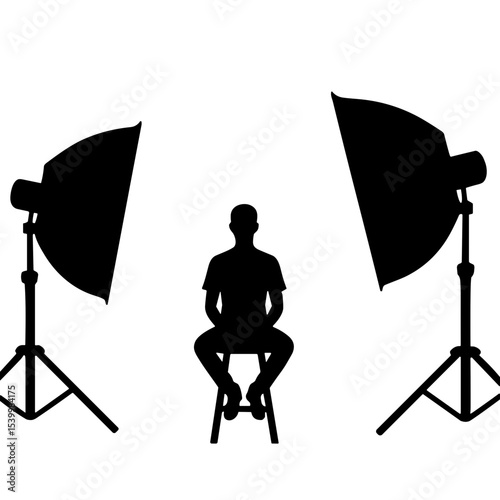 Silhouette of a model sitting on stool in studio with lighting equipment  
