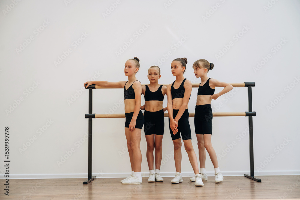 Fototapeta premium Girls practicing ballet indoors in the class
