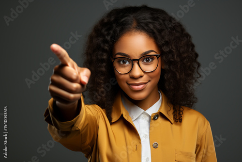Studio Portrait of Positive Dark-Skinned Girl Smiling Confidently