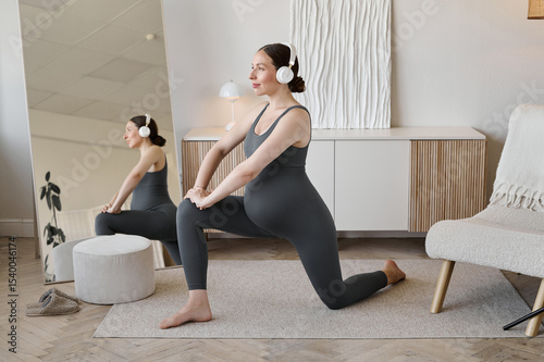 Pregnant woman doing prenatal fitness exercise at home